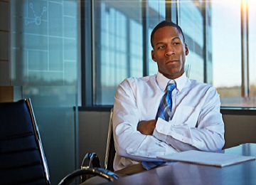 Male CEO alone in thought from office